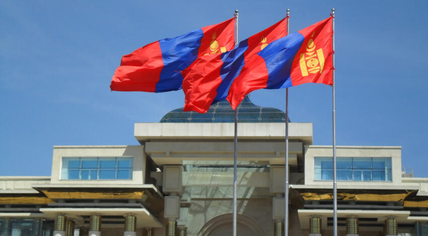 Three Mongolian flags flying in front of the Government Palace on Sukhbaatar Square, Ulaanbaatar.