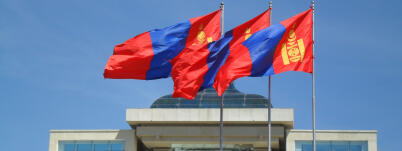 Three Mongolian flags flying in front of the Government Palace on Sukhbaatar Square, Ulaanbaatar.