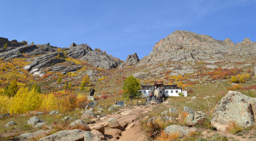 Ariyabal Buddhist Meditation Temple nestled among autumn foliage and granite rocks in Terelj National Park.