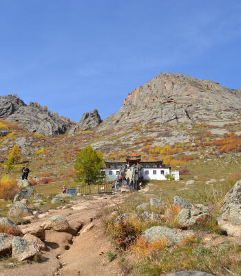 Ariyabal Buddhist Meditation Temple nestled among autumn foliage and granite rocks in Terelj National Park.