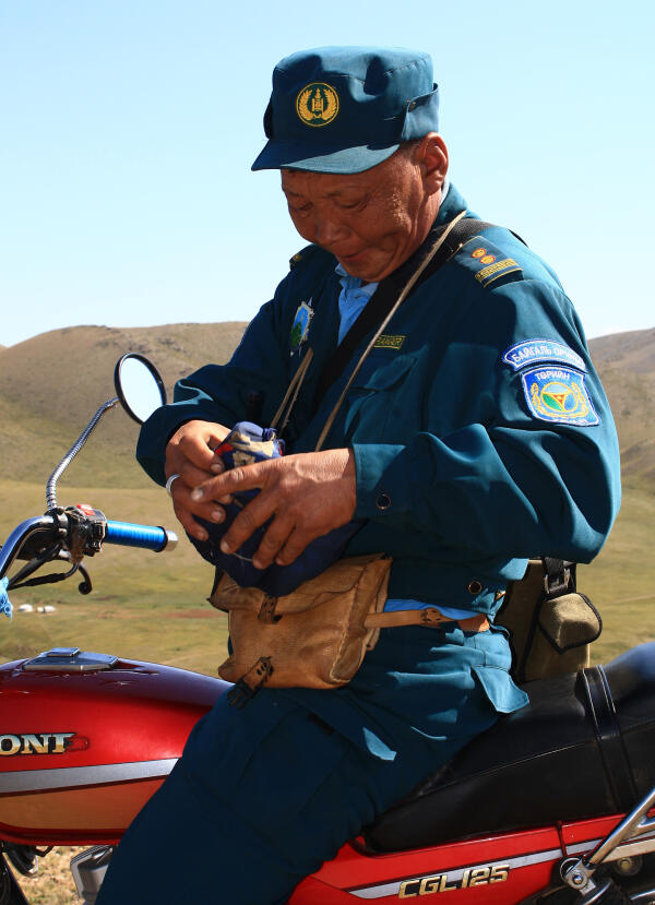 A Khustai National Park ranger sitting on his motorcycle.
